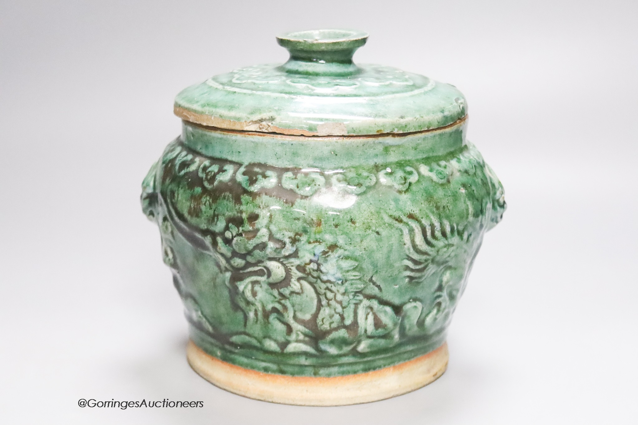 A 19th century Chinese green glazed jar and cover, height 19cm